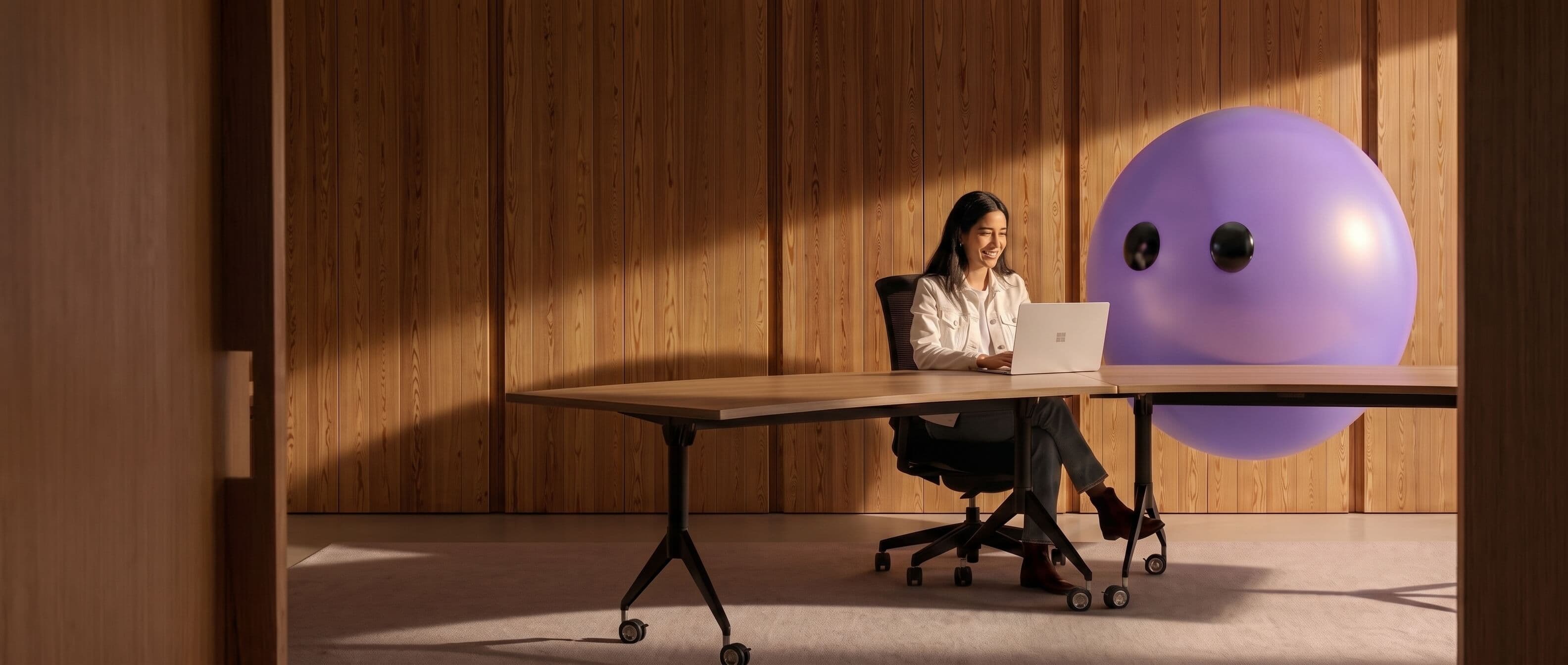Support agent working at a laptop next to the Lyro mascot
