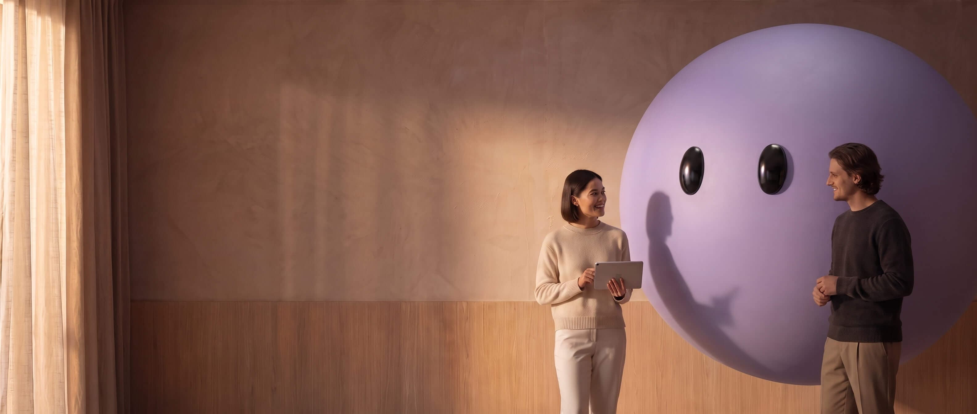 Two colleagues reviewing a tablet beside the purple Lyro mascot