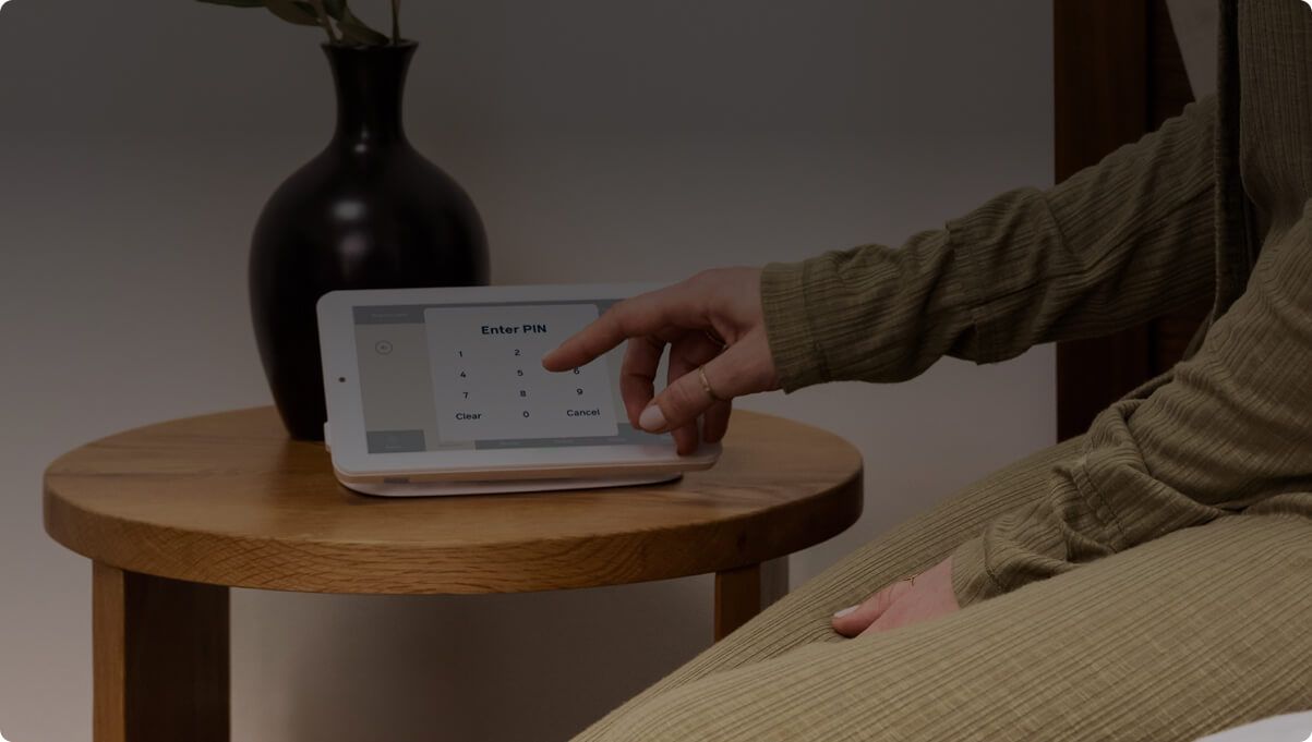 Person entering a PIN on a Cove home security keypad